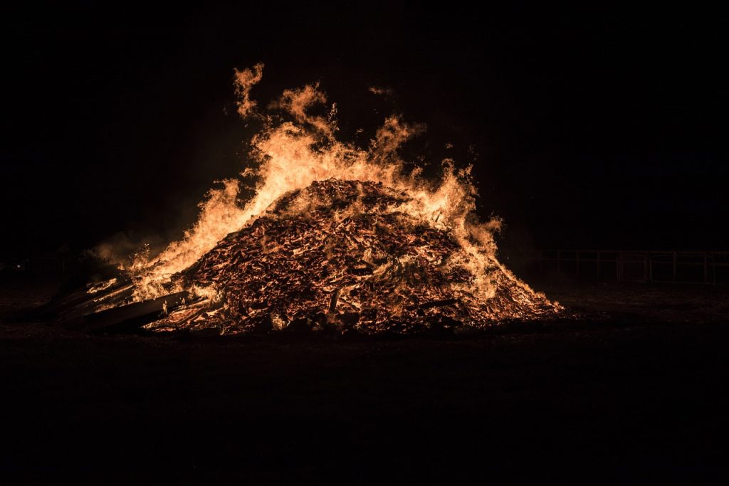 People build towering pyres using wood, old furniture, and other flammable materials.